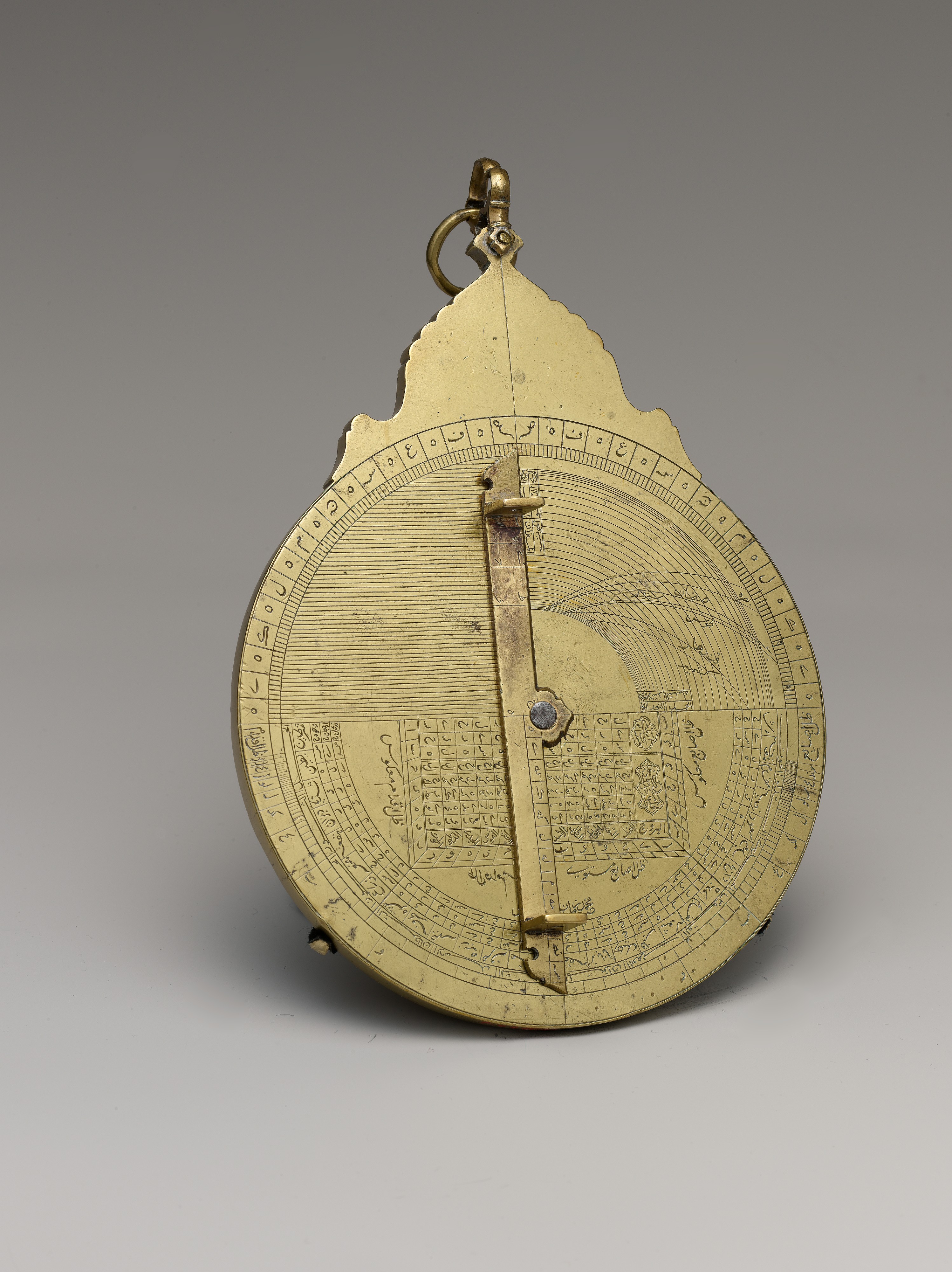 Reverse of the astrolabe showing engraved circular scales and a straight rotating rule.